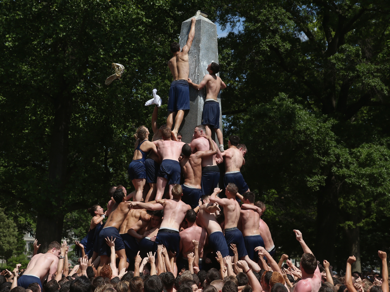 Illustration for article titled Gallery: Greasy Naval Cadets Try To Climb A Lard-Covered Monument